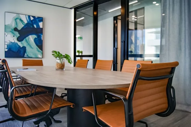 an office with conference table and chairs around it
